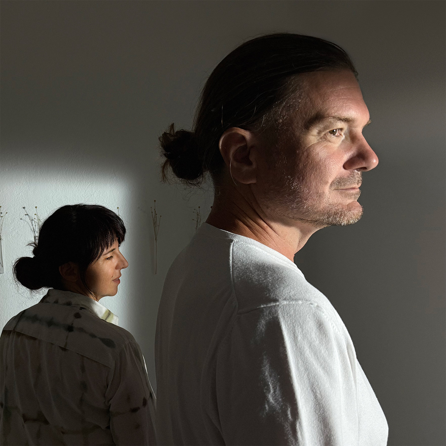 Portrait of Vesna and Vjeran in Atelier Arhe on Ciovo near Trogir, captured in artistic light and shadow, representing relaxing treatment inspired by shiatsu.